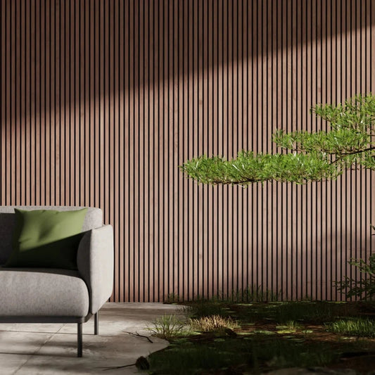 Interior shot: gray sofa with green cushion, wood-slatted wall, bonsai tree, grass.