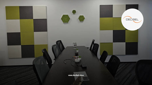 office conference room with table nad chairs, acoustically treated with square textile panels on the wall in green, white and grey