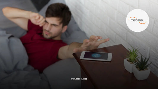 man snoozing his phone alarm in the morning