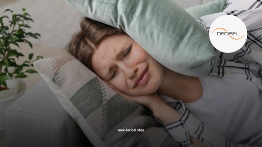 a woman on a sofa covering her ears with a pillow because of the strong noise around her