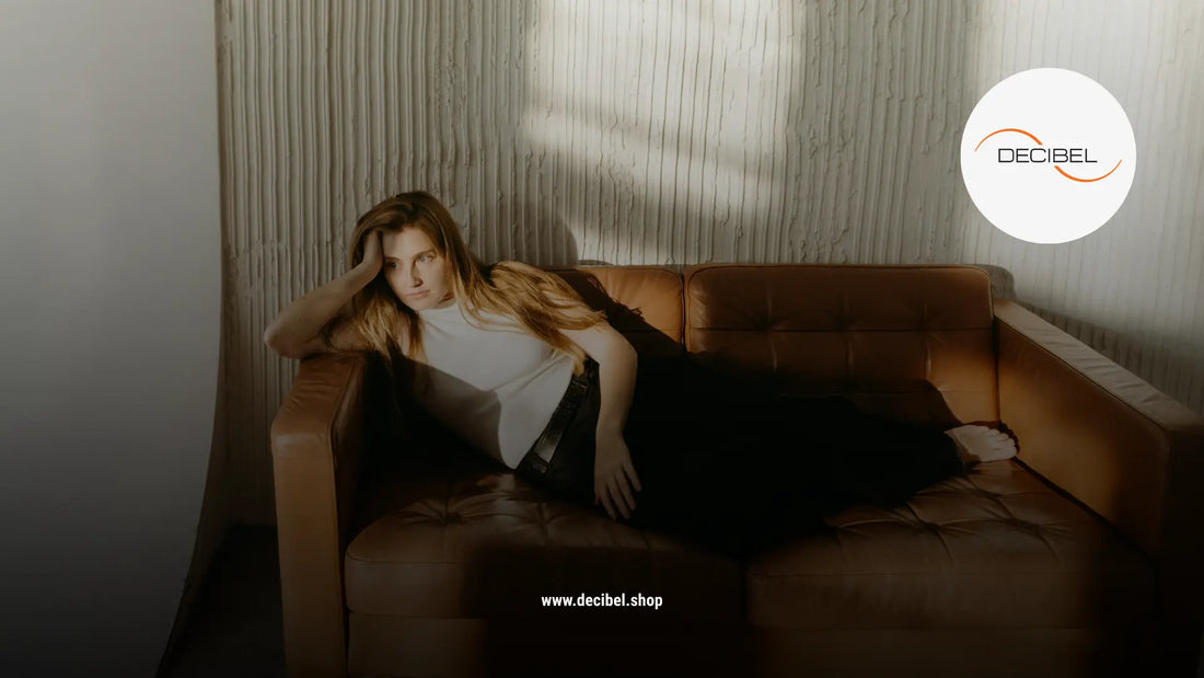 thinking woman with a white blouse without sleeves on a couch 