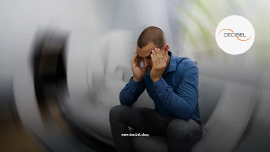 man sitting on a sofa with hand on his head with a blurry background