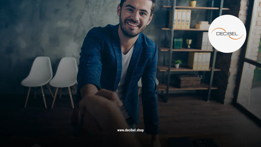 man with a blue jacket welcoming his guest with a handshake