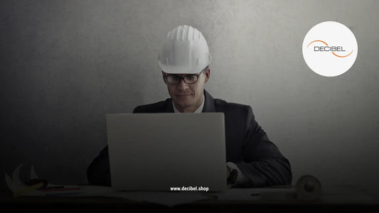 man with a helmet in front of a laptop