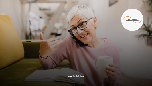 mature woman with short white hair talking on a phone with a cup of coffee in hand